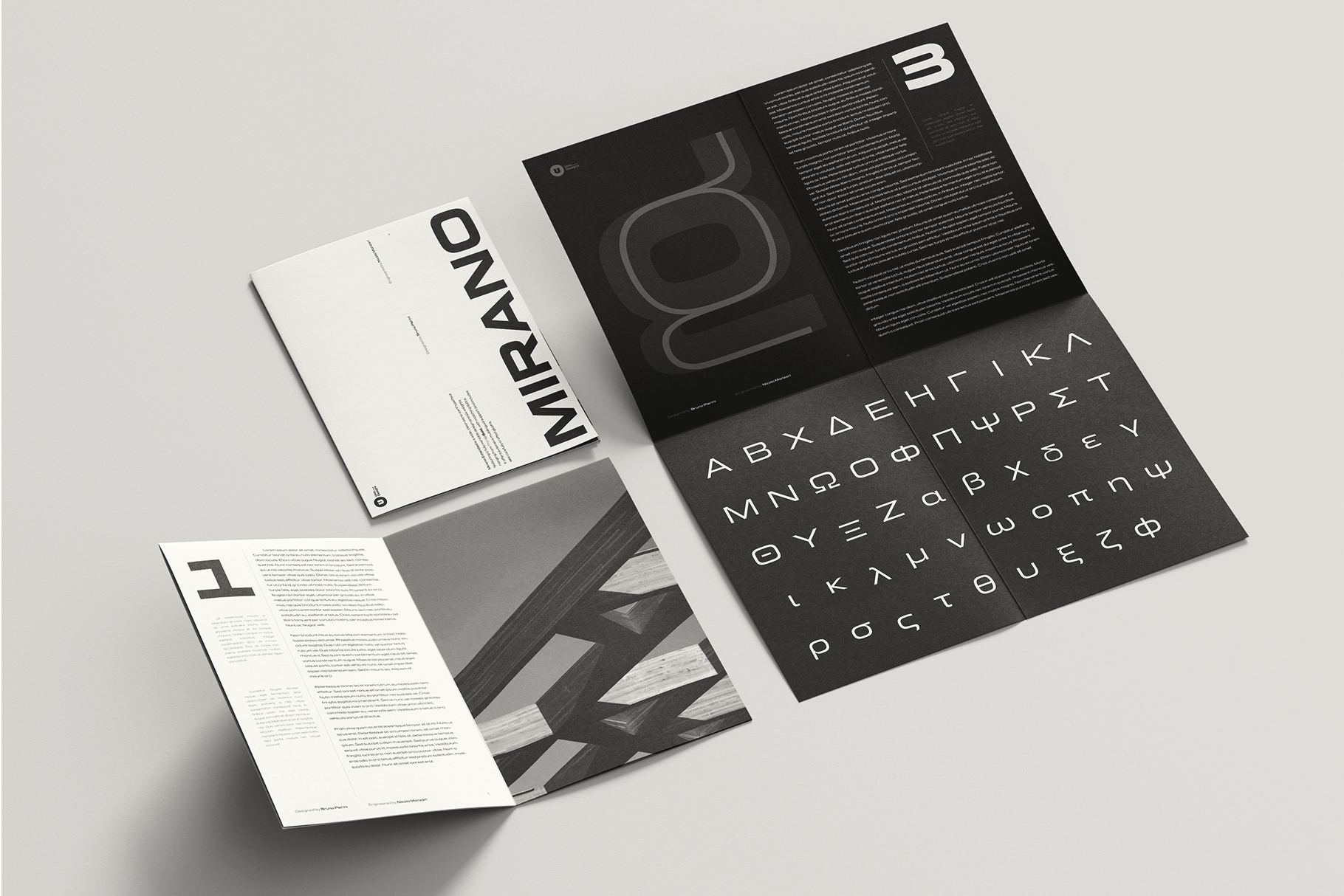 Branding mockup showing folded brochures with minimalist design, Greek typography, black, white, gray color scheme