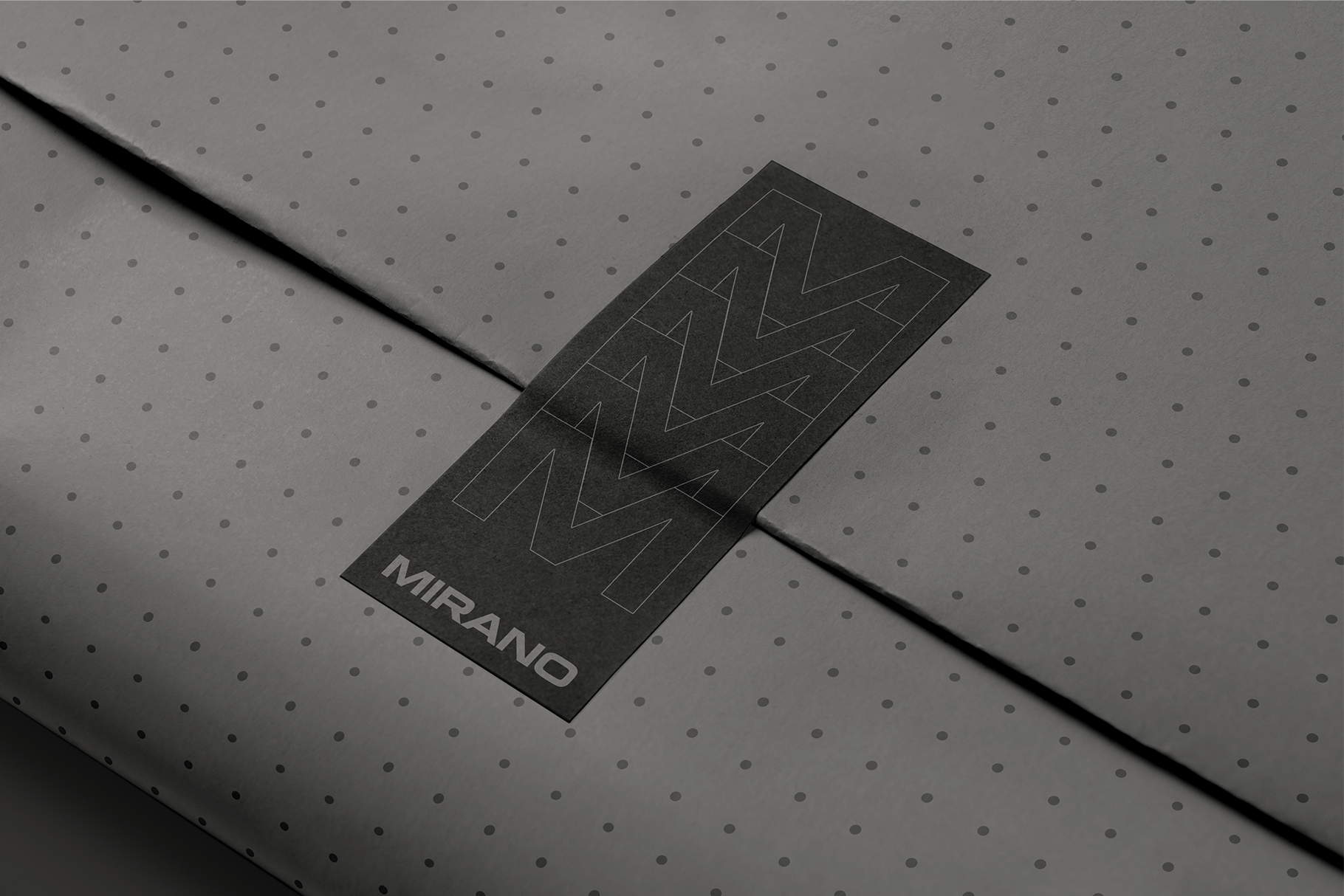 Black business card with geometric triangle pattern on dotted surface mockup