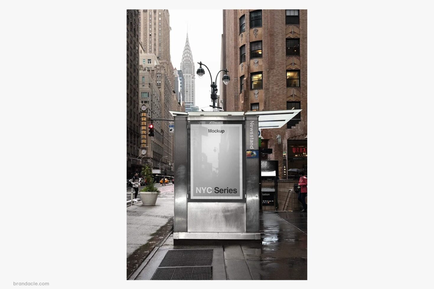 Street level NYC kiosk with blank poster mockup, Chrysler Building visible behind brick architecture