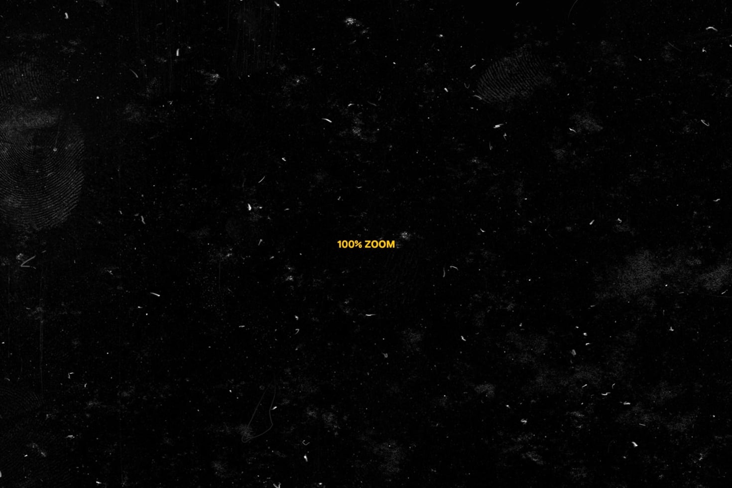 Gritty black texture overlay with yellow "100% ZOOM" text in center
