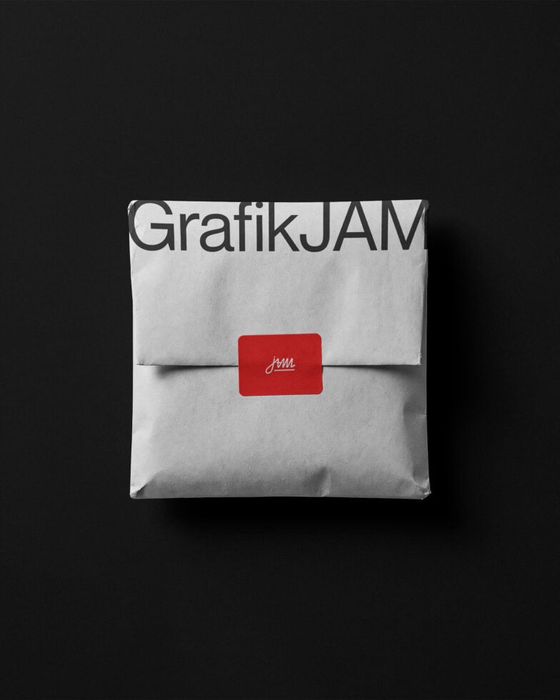 Folded white envelope mockup with GrafikJAM branding, red seal label on dark background