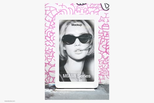 Phone mockup with pink graffiti frame showing black-white portrait of woman in sunglasses