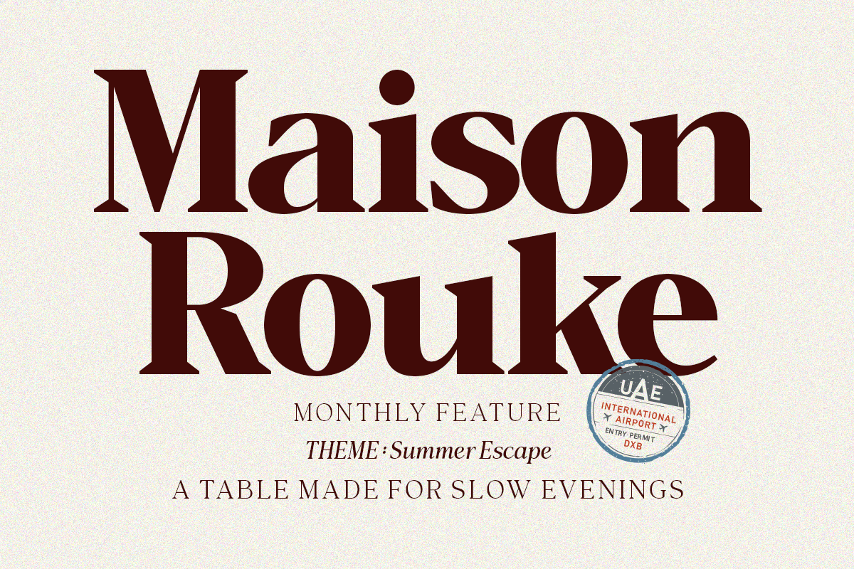 Maison Roulke magazine cover mockup with burgundy serif type, summer escape theme, airport stamp