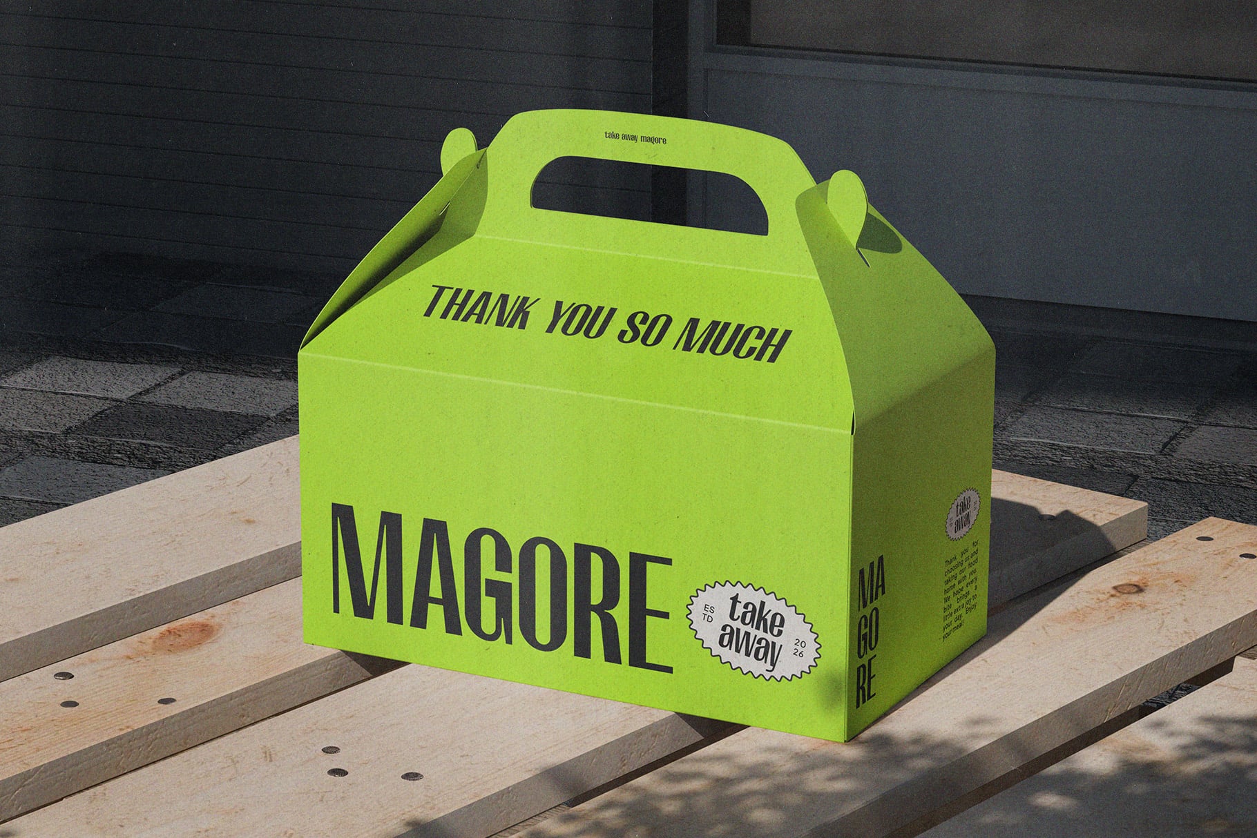 Neon yellow takeout box mockup with "MAGORE" branding on wooden deck