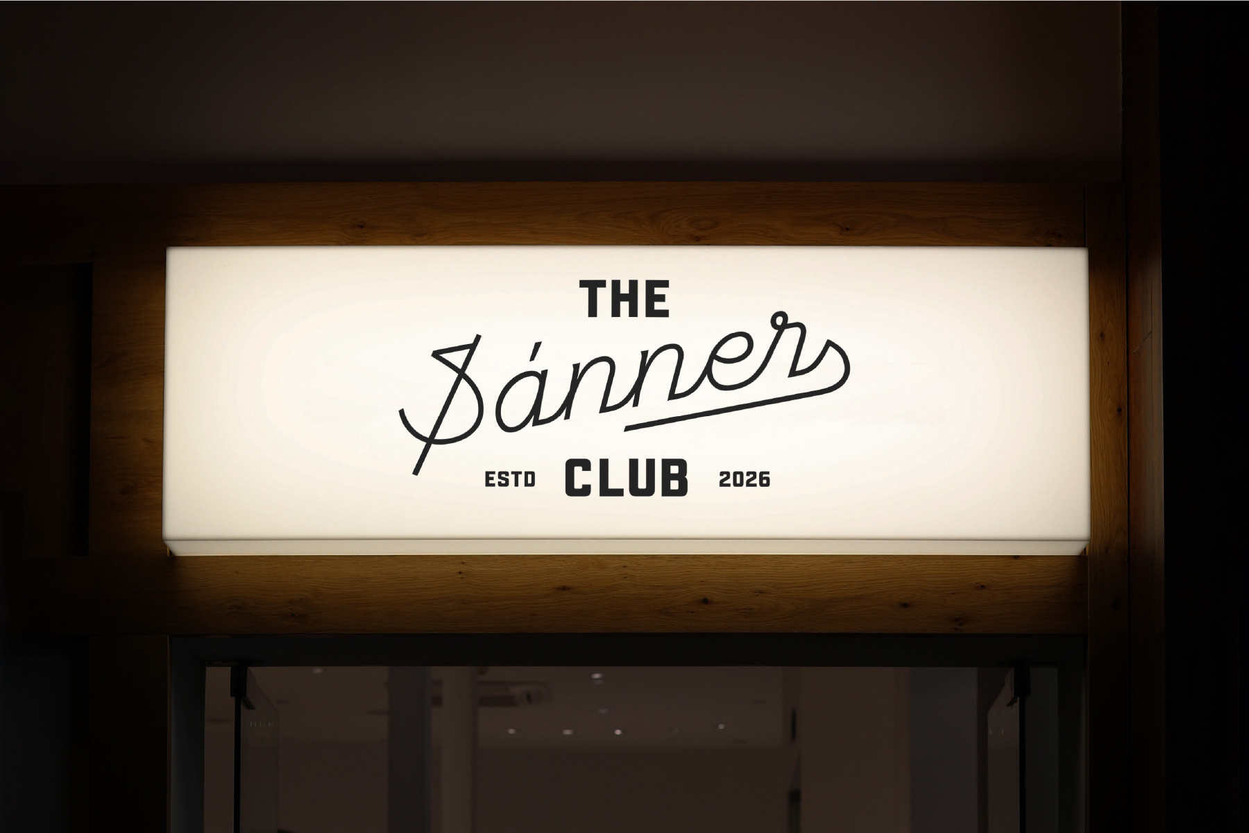 Illuminated storefront sign reading "The Banners Club ESTD 2026" with script lettering on cream background