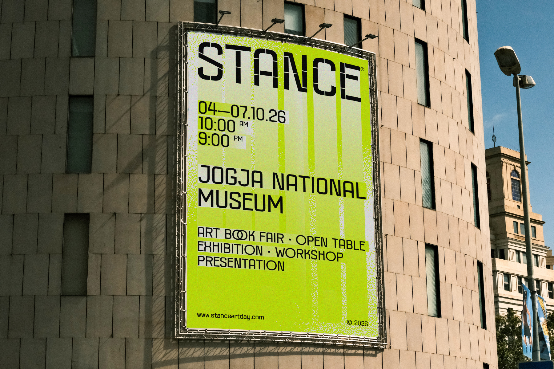 Neon yellow billboard on brick building advertising Stance art event at Jogja museum