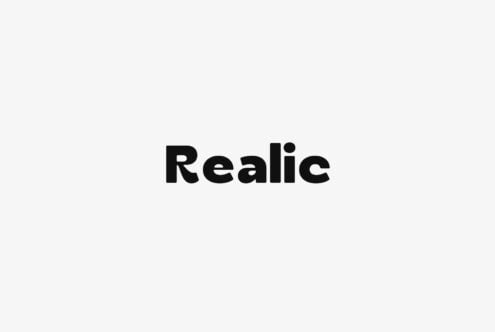 Realic typeface in bold black letters on light gray background