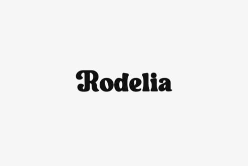 Rodelia serif typeface in bold black on light gray background