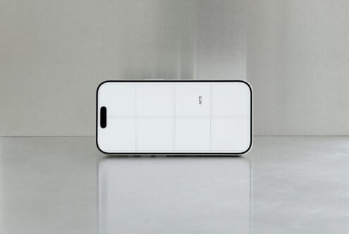 iPhone 14 Pro mockup landscape with grid overlay on minimal gray surface