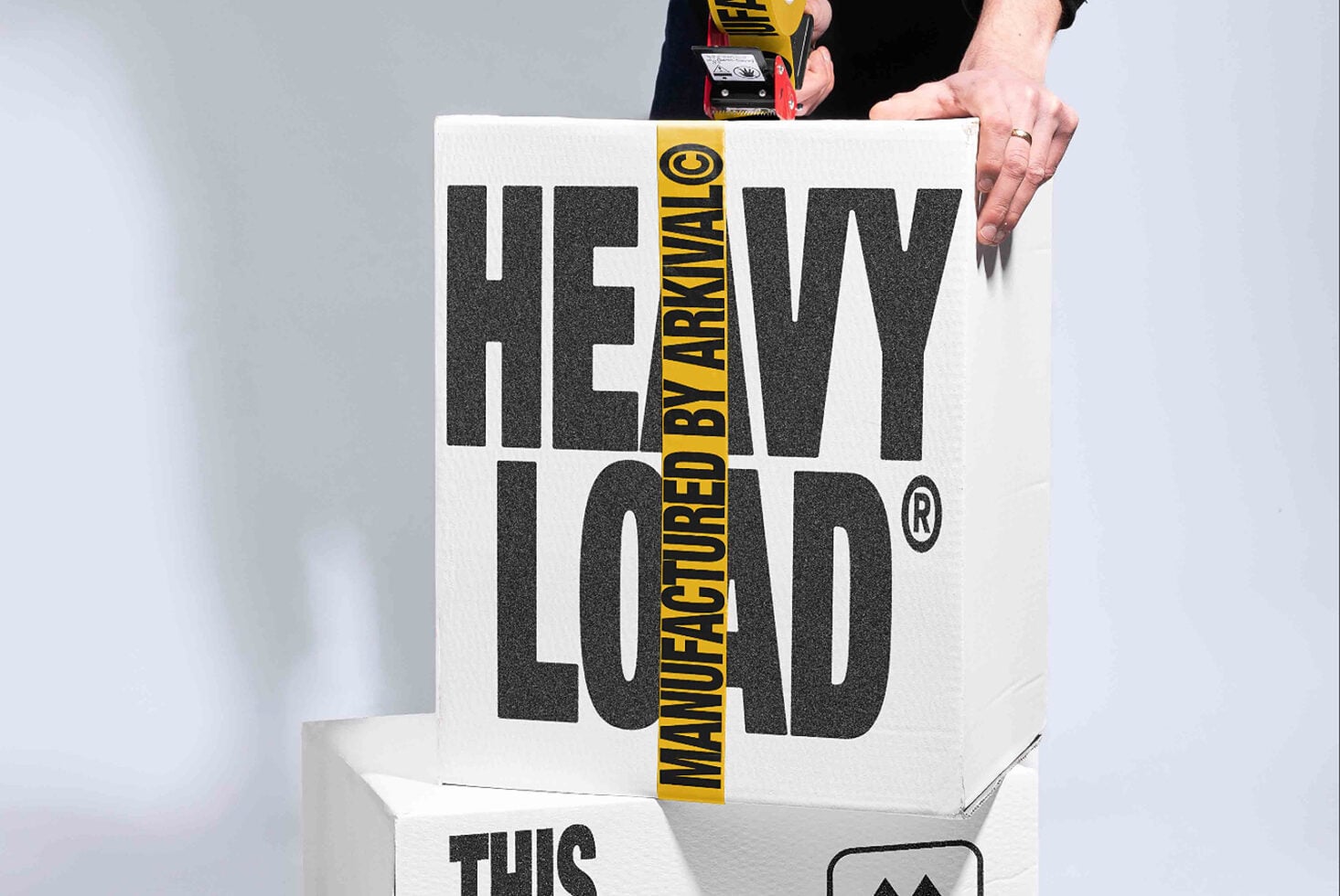 Heavy load box mockup with measure tape crossing over textured typography