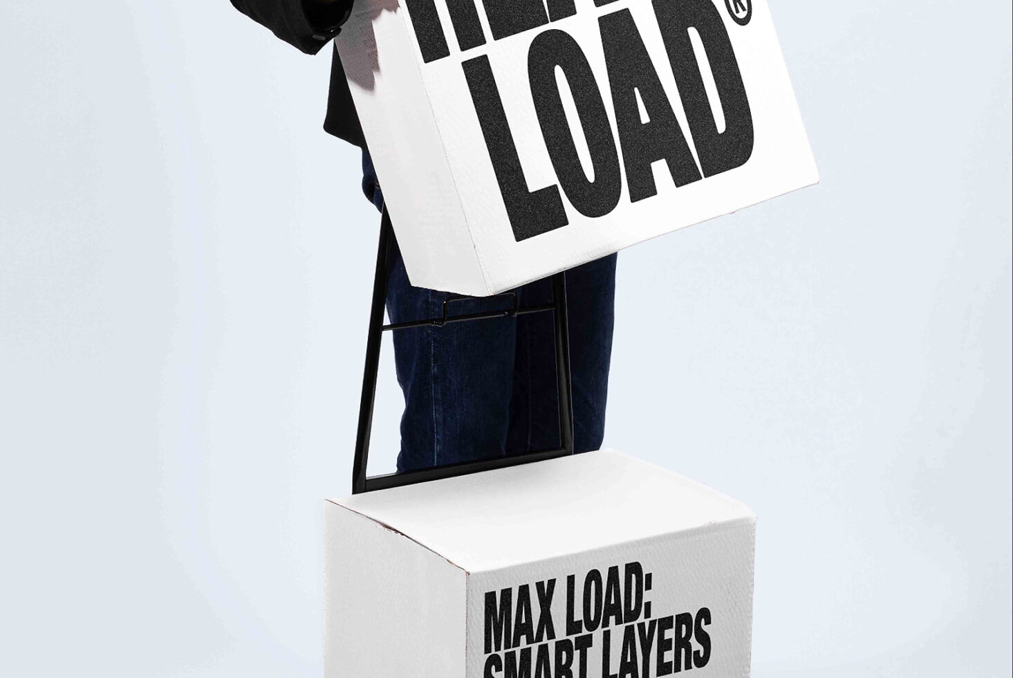 Person holding white tote bag with bold black typography over denim pocket detail mockup