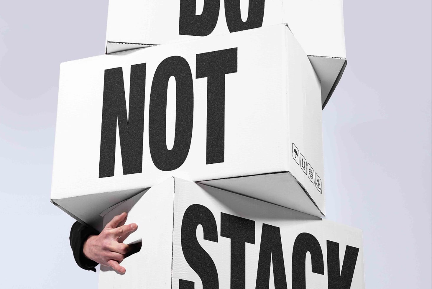 Do not stop 3D box mockup with folded flaps, hand holding corner, bold typography
