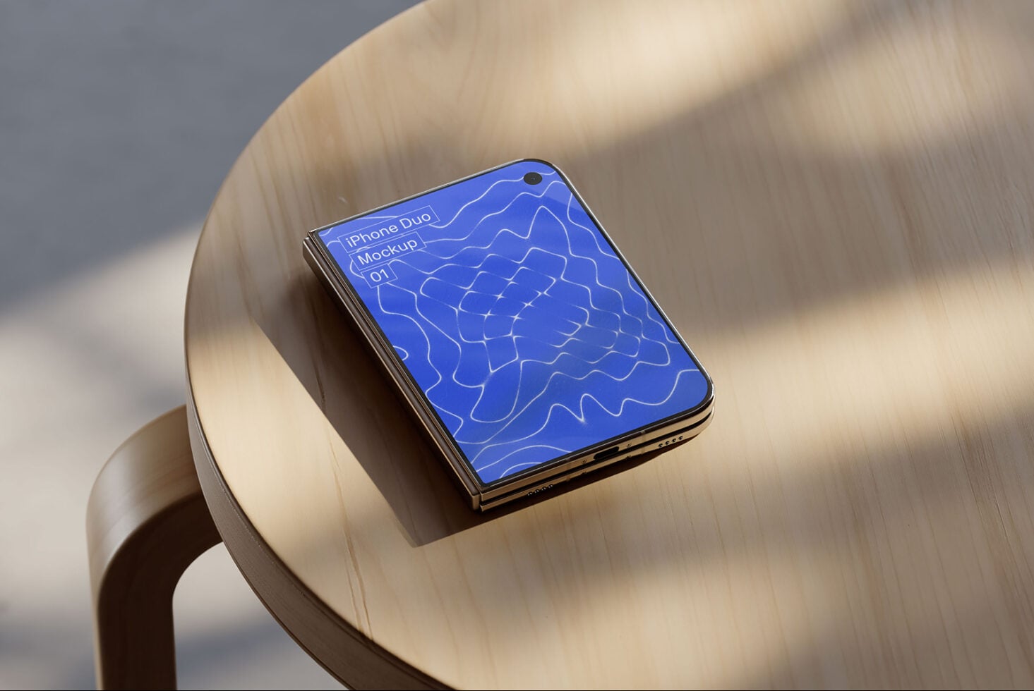 iPhone Duo mockup sitting on cream ceramic chair with blue abstract pattern on screen