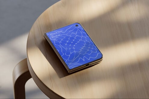 iPhone Duo mockup sitting on cream ceramic chair with blue abstract pattern on screen