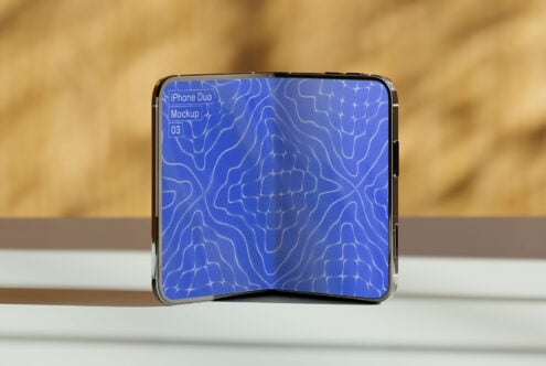 Folded iPhone Duo displaying blue topographic pattern on screen in natural daylight