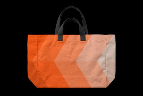 Orange gradient tote bag mockup with black handles on black background
