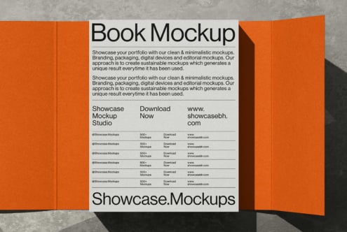 Open book mockup with vibrant orange covers displaying minimalist portfolio layout on cream page