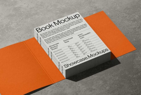 Open book mockup with bright orange cover on concrete background with shadow