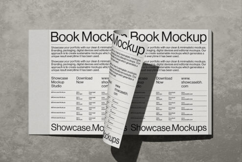 Open book mockup with minimalist design showing portfolio layouts on concrete background with shadows