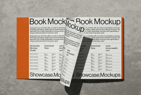 Open book mockup with orange spine showing minimalist design layouts on concrete background