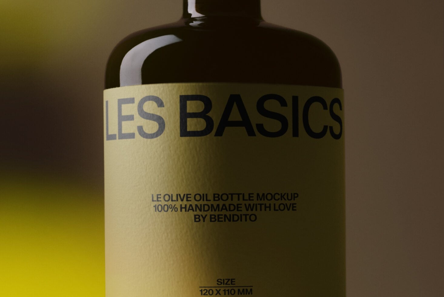 Dark glass bottle with cream label reading "LES BASICS" olive oil mockup by Bendito