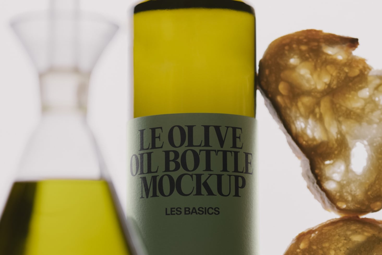 Olive oil bottle mockup with sage green label, styled with fresh olives on marble surface