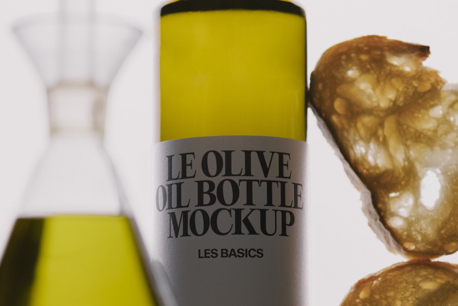 Olive oil bottle mockup with yellow label, styled with fresh olives on marble background