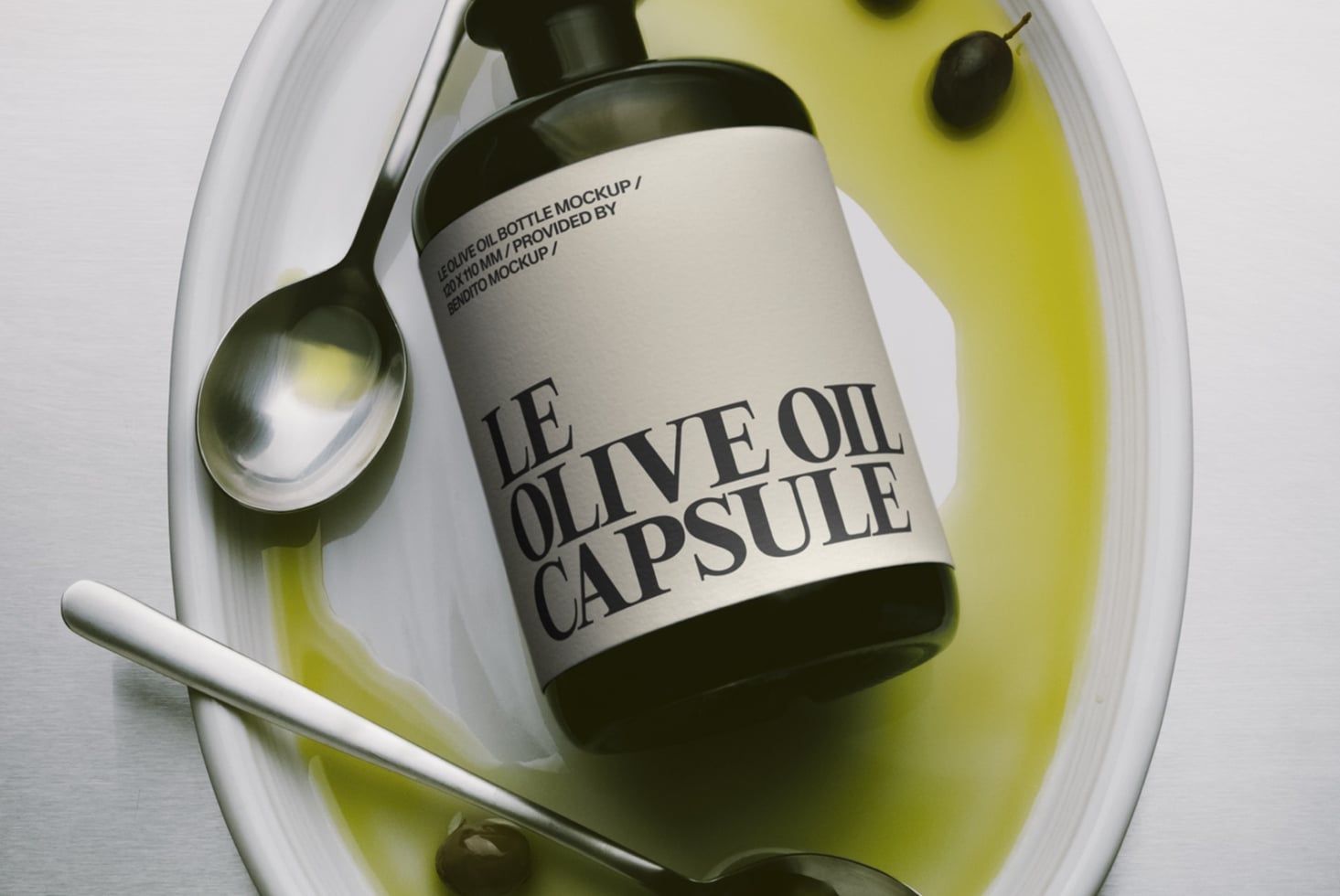 Olive oil capsule bottle mockup with spoon in ceramic dish filled with golden oil