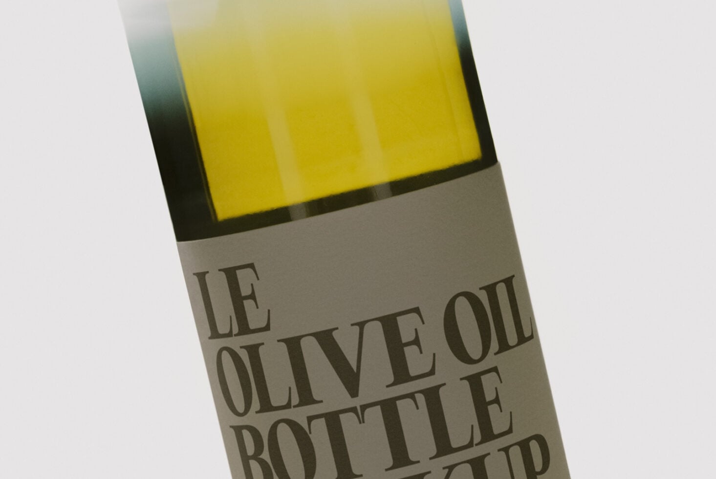 Olive oil bottle mockup with bright yellow label on angled white background