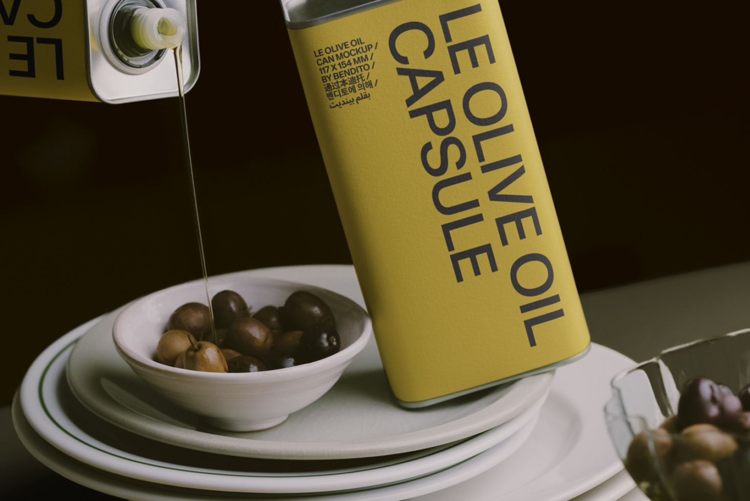 Yellow olive oil can mockup pouring into bowl with olives on stacked plates