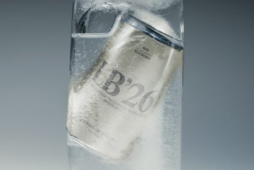 Frosted glass bottle with condensation, label showing size specs, product mockup shot from above