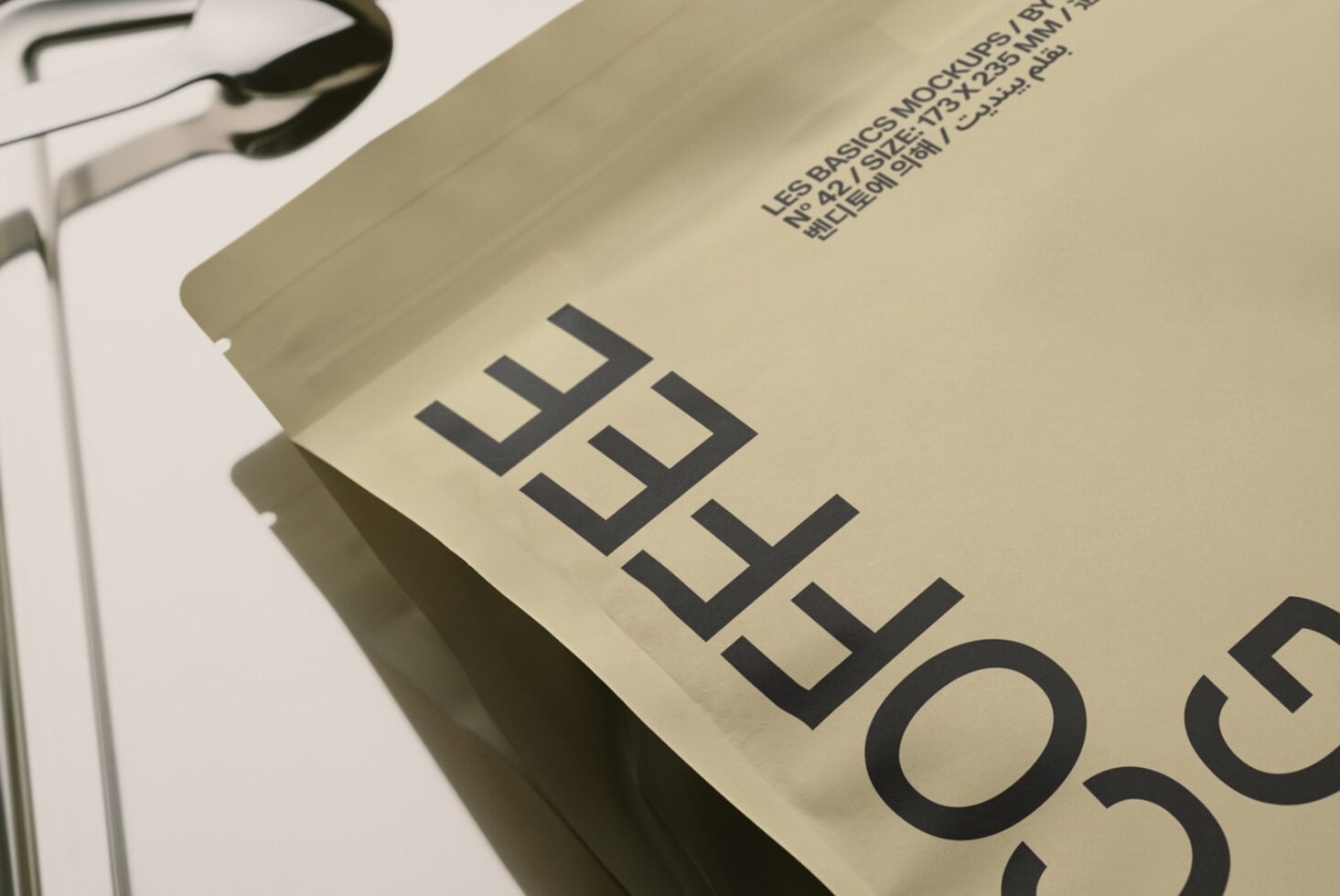 Cream colored box mockup with bold black geometric lettering, angled product shot showing texture details
