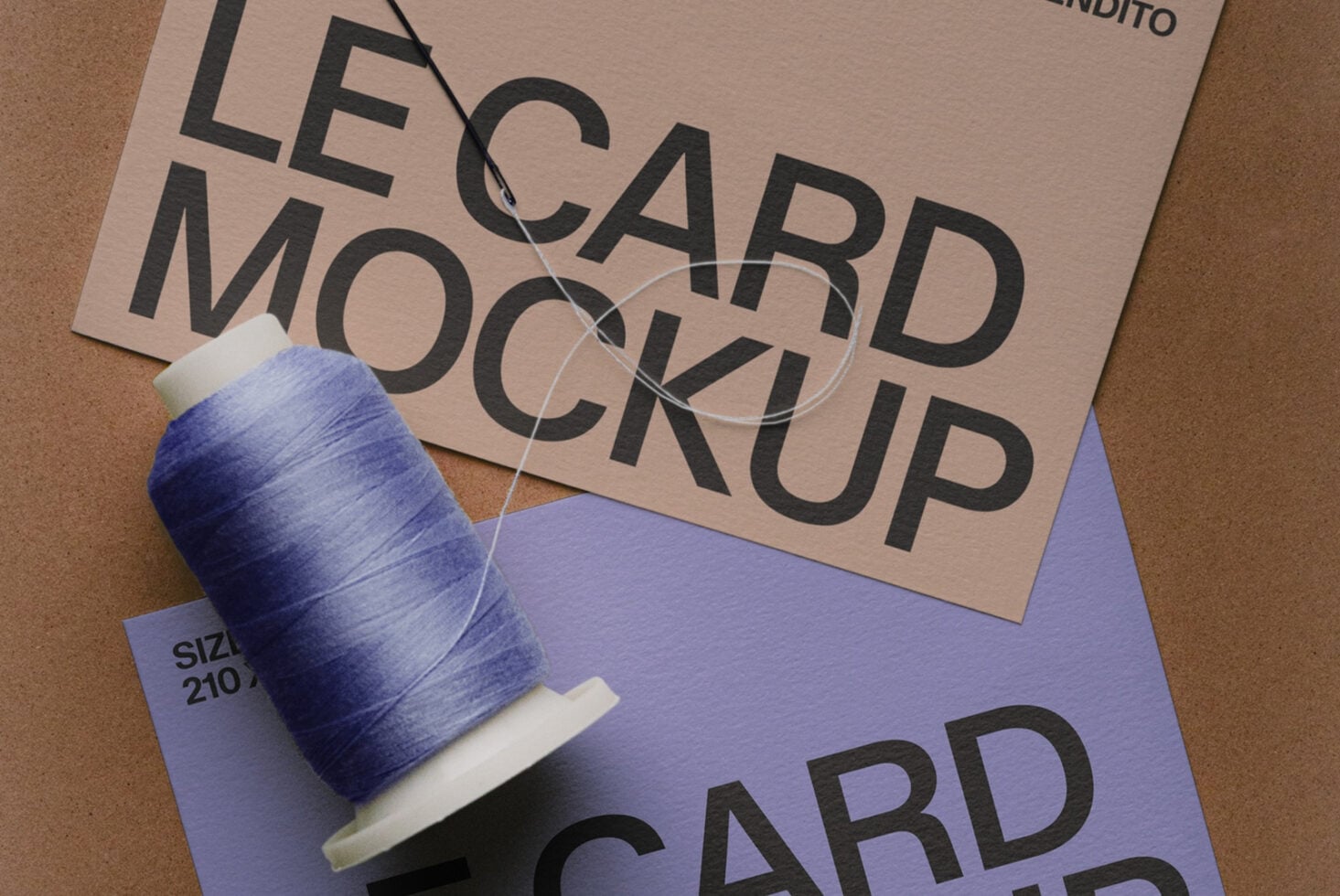 Business card mockup with blue thread spool on kraft textured background