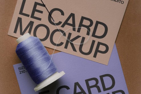 Business card mockup with blue thread spool on kraft textured background
