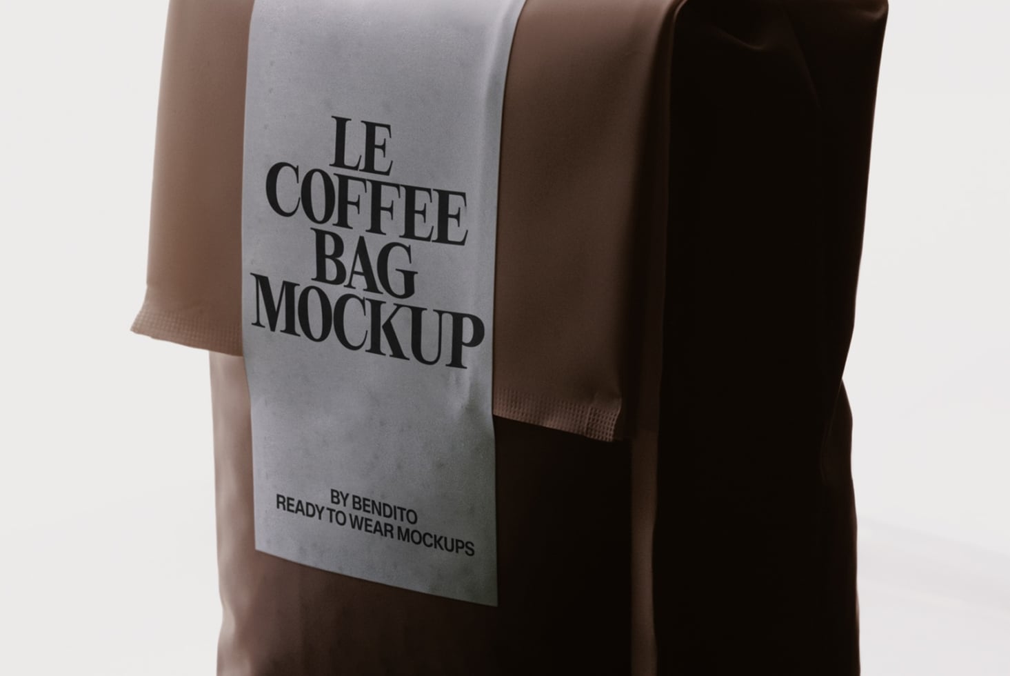 Three coffee bags in earth tones stacked together, front bag showing serif typography mockup