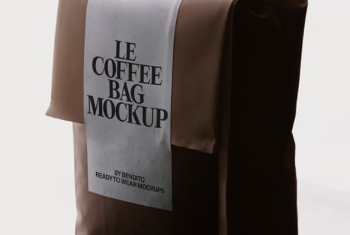 Three coffee bags in earth tones stacked together, front bag showing serif typography mockup