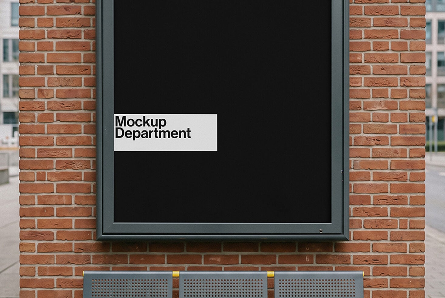 Black storefront window display on brick building with white label reading Mockup Department