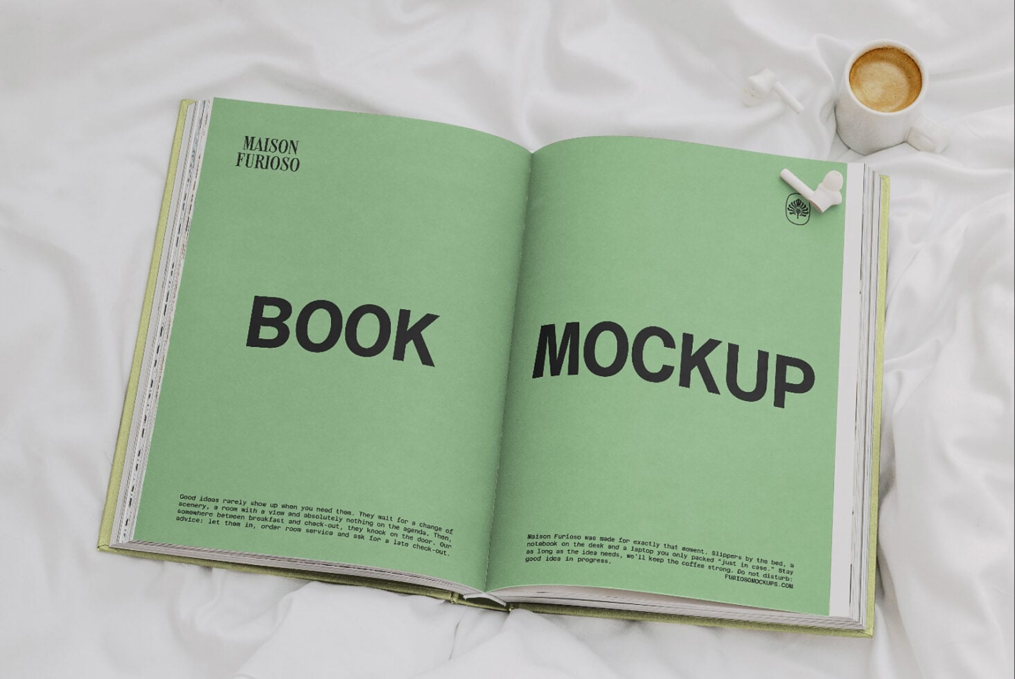 Open magazine spread with bright green pages showing "BOOK MOCKUP" text, coffee cup nearby on white fabric backdrop
