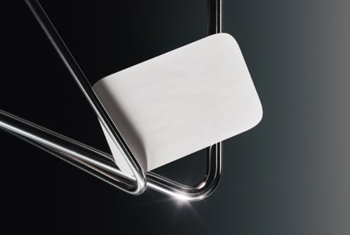 Blank white rounded card held between glass tubes on dark background