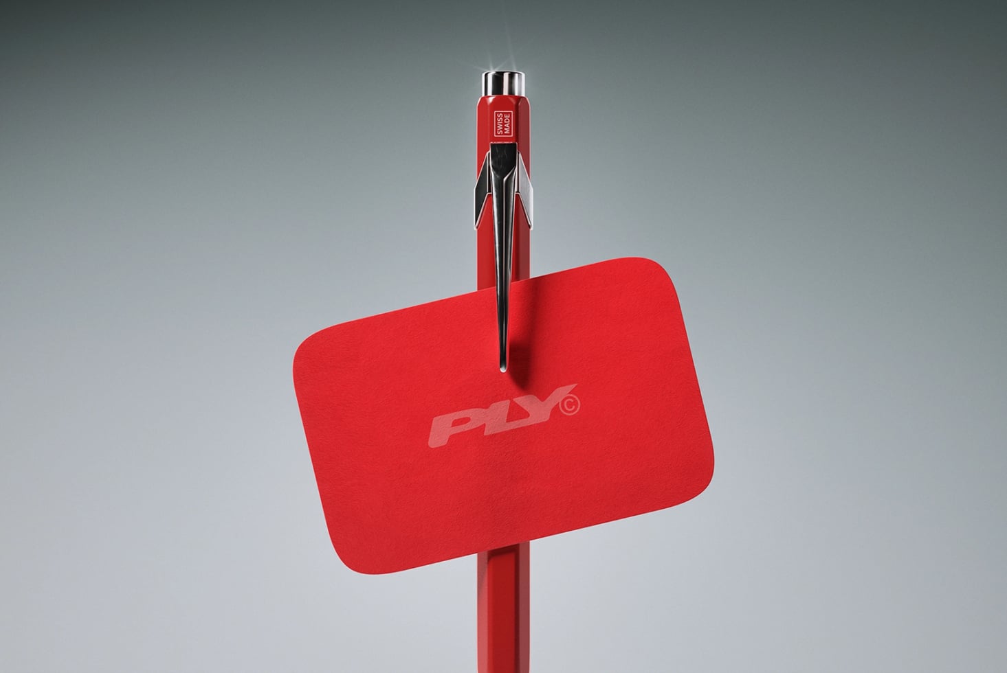 Red pen mockup with rounded label tag on gray background, chrome details visible