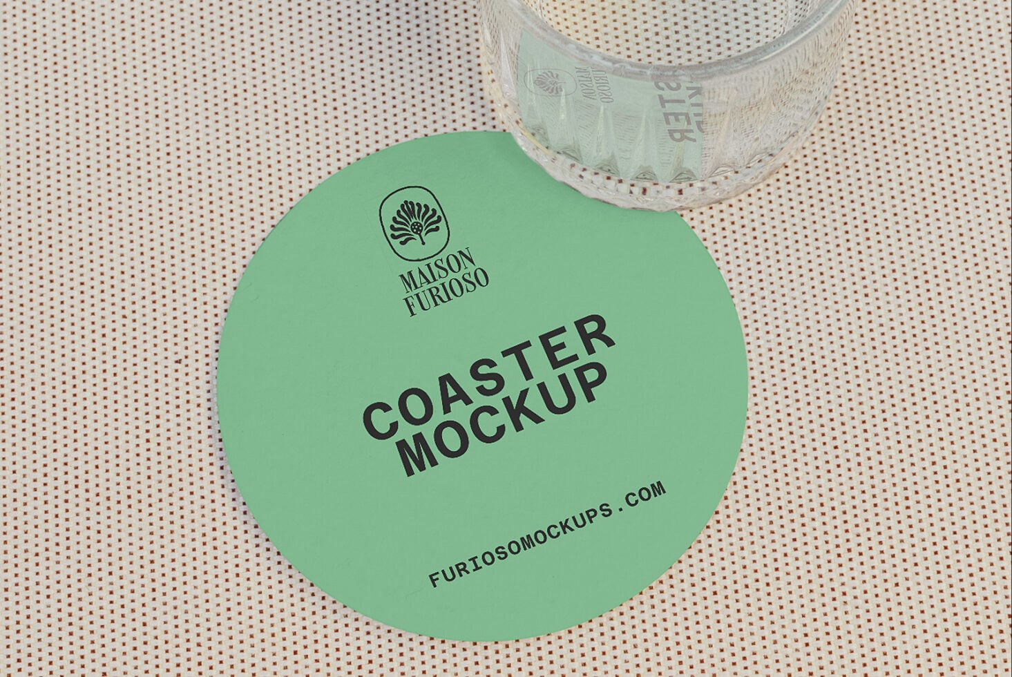 Mint green round coaster mockup with logo, next to clear packing tape on dotted fabric background
