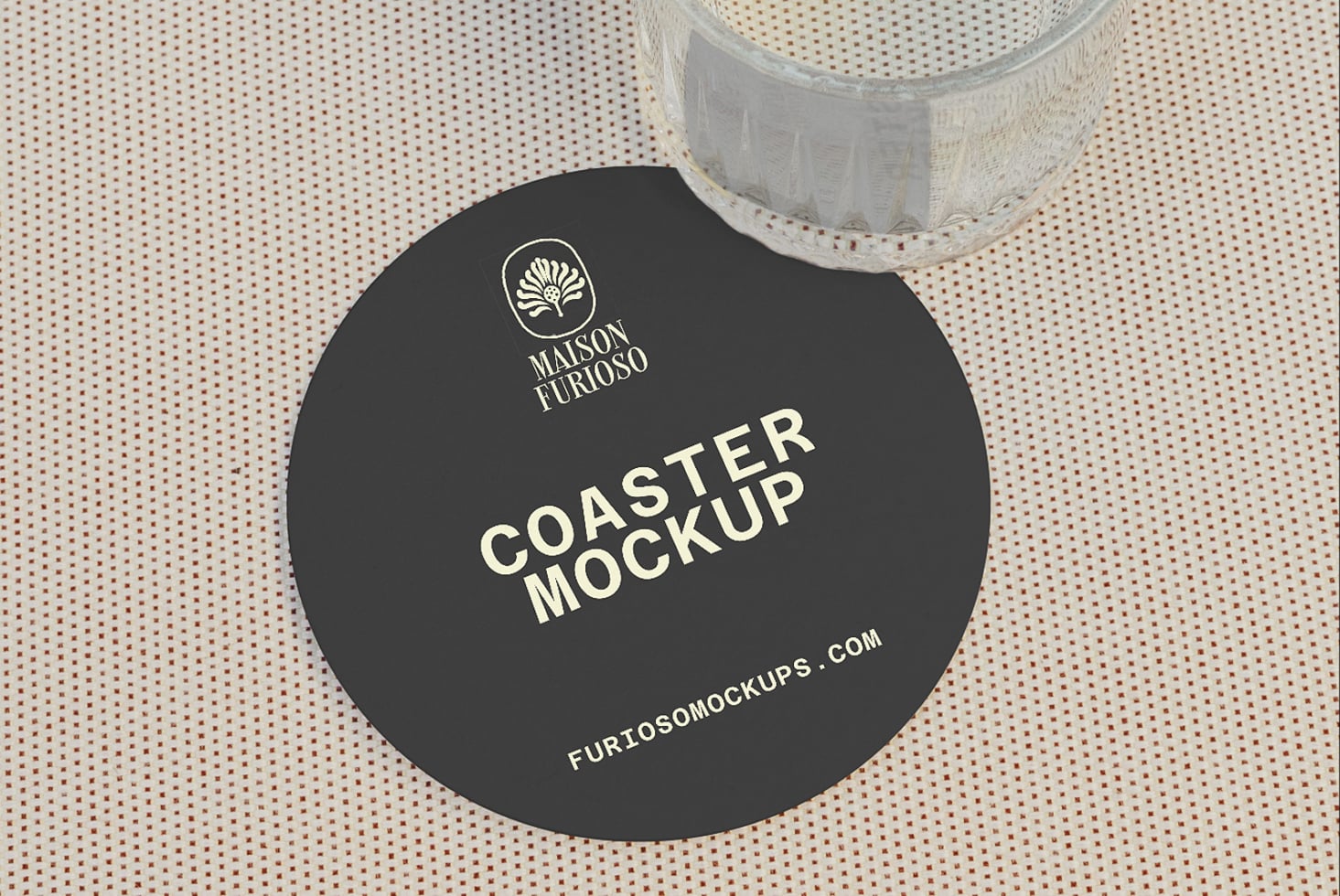 Black round coaster mockup with logo, styled on textured beige fabric with white tape roll