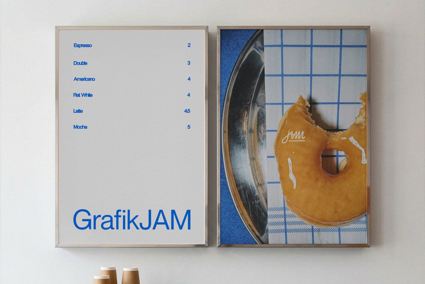 Two framed posters showing coffee menu on left, golden guitar with blue grid on right