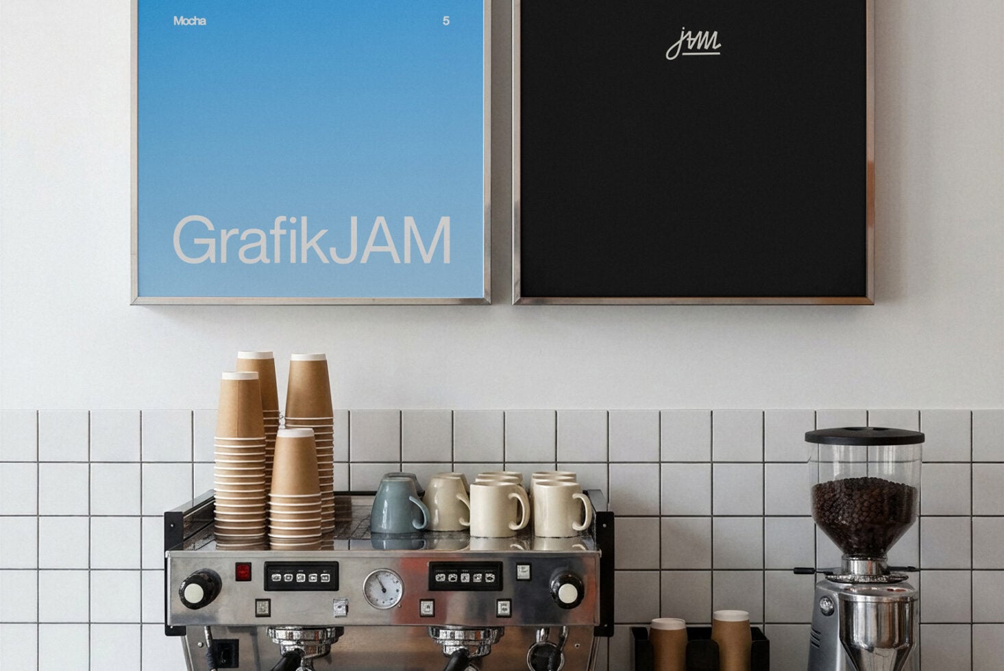 Coffee shop counter setup with espresso machine, stacked cups, grinder, plus blue poster above