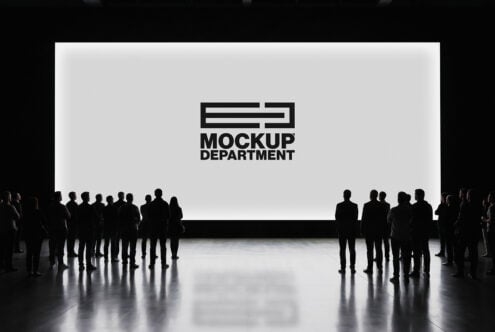 Silhouettes of people gathered in front of a large projection screen displaying Mockup Department logo
