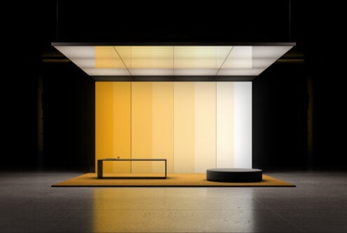 Modern retail storefront mockup with yellow gradient panels, sleek black bench, circular display platform, overhead lighting
