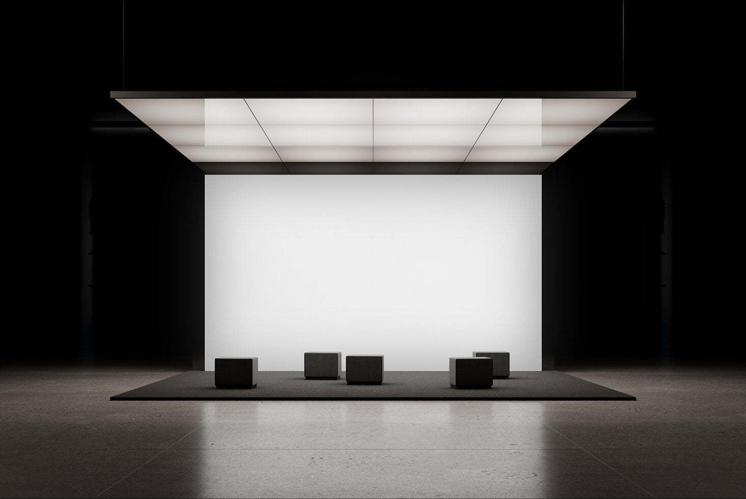 Minimalist trade show booth with blank white panel, overhead grid lighting, black seating cubes on platform