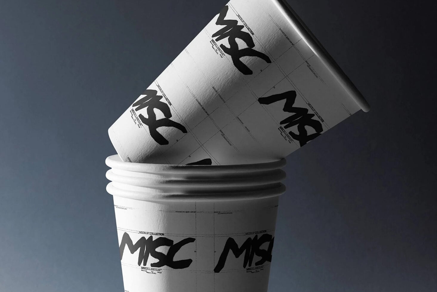 Stacked paper coffee cups with bold black logo mockup on white, angled shot