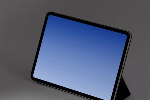 Tablet mockup with blue screen sitting at an angle on gray background