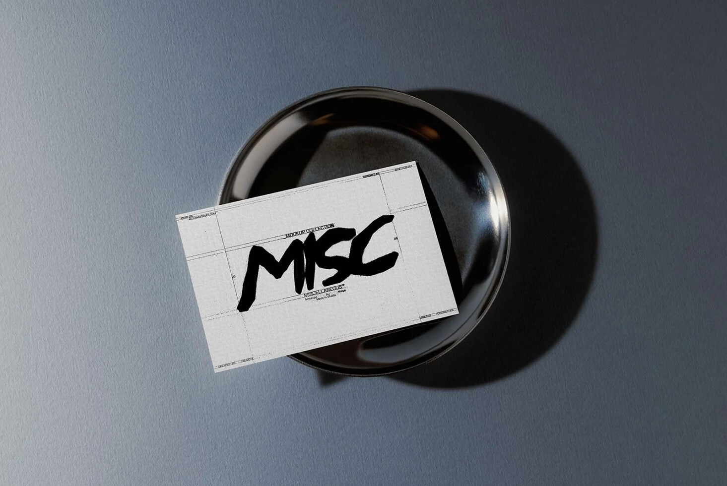 Business card mockup with black bowl on blue gray background showing MSC logo